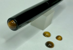 Illuminaire in Solid Black Ebonite with Tiger's Eye Cabochons